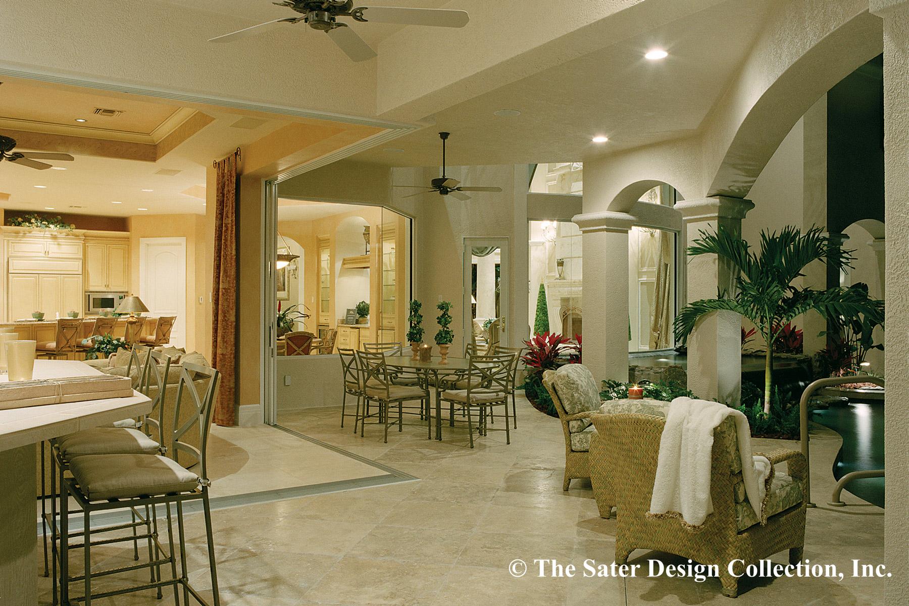 Open concept interior and covered patio with kitchen, dining area, fireplace, and seating.