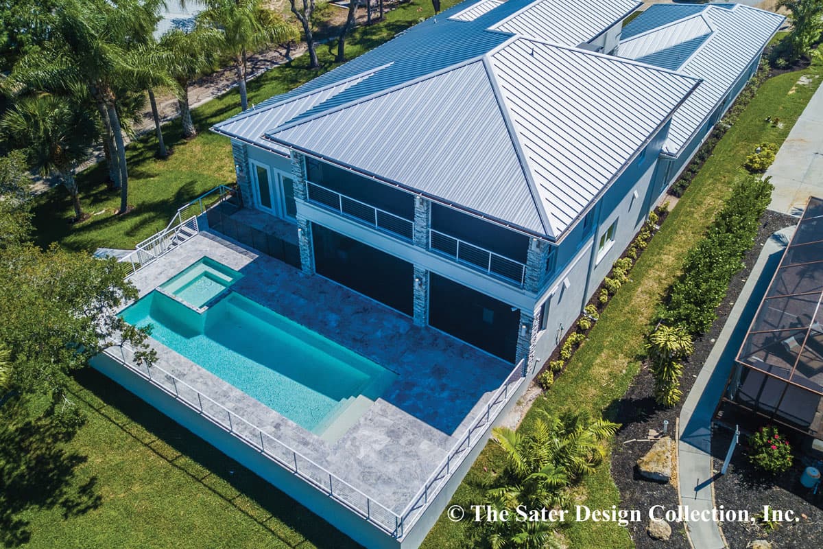 Two-story house plan exterior with metal roof, screened-in balcony, and swimming pool with spa.