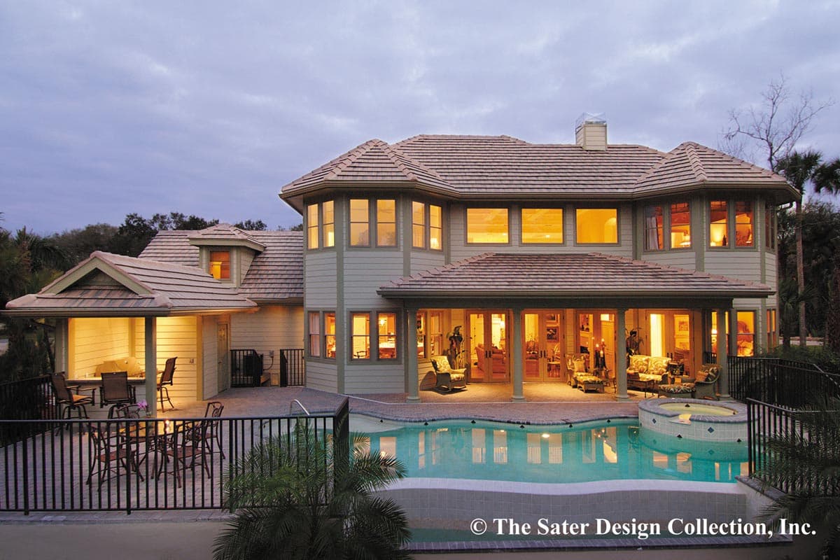 House plan exterior. Two-story home with covered porch, gabled dormer, multi-level rooflines, and pool.