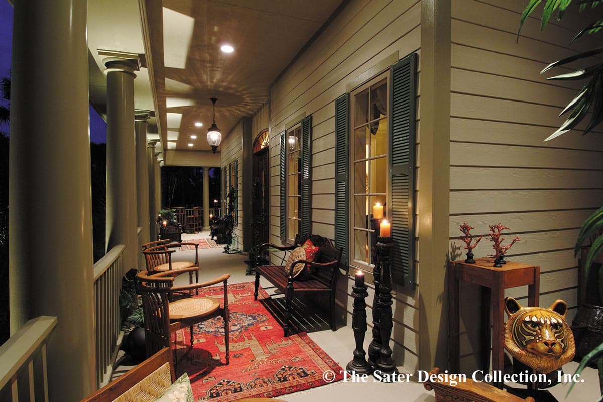 Wraparound porch with columns, paneled siding, louvered shutters, and outdoor seating.