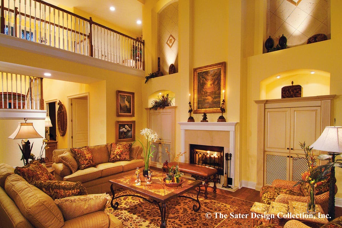 Interior living room with fireplace, vaulted ceiling, second-story balcony, and ornate furnishings.
