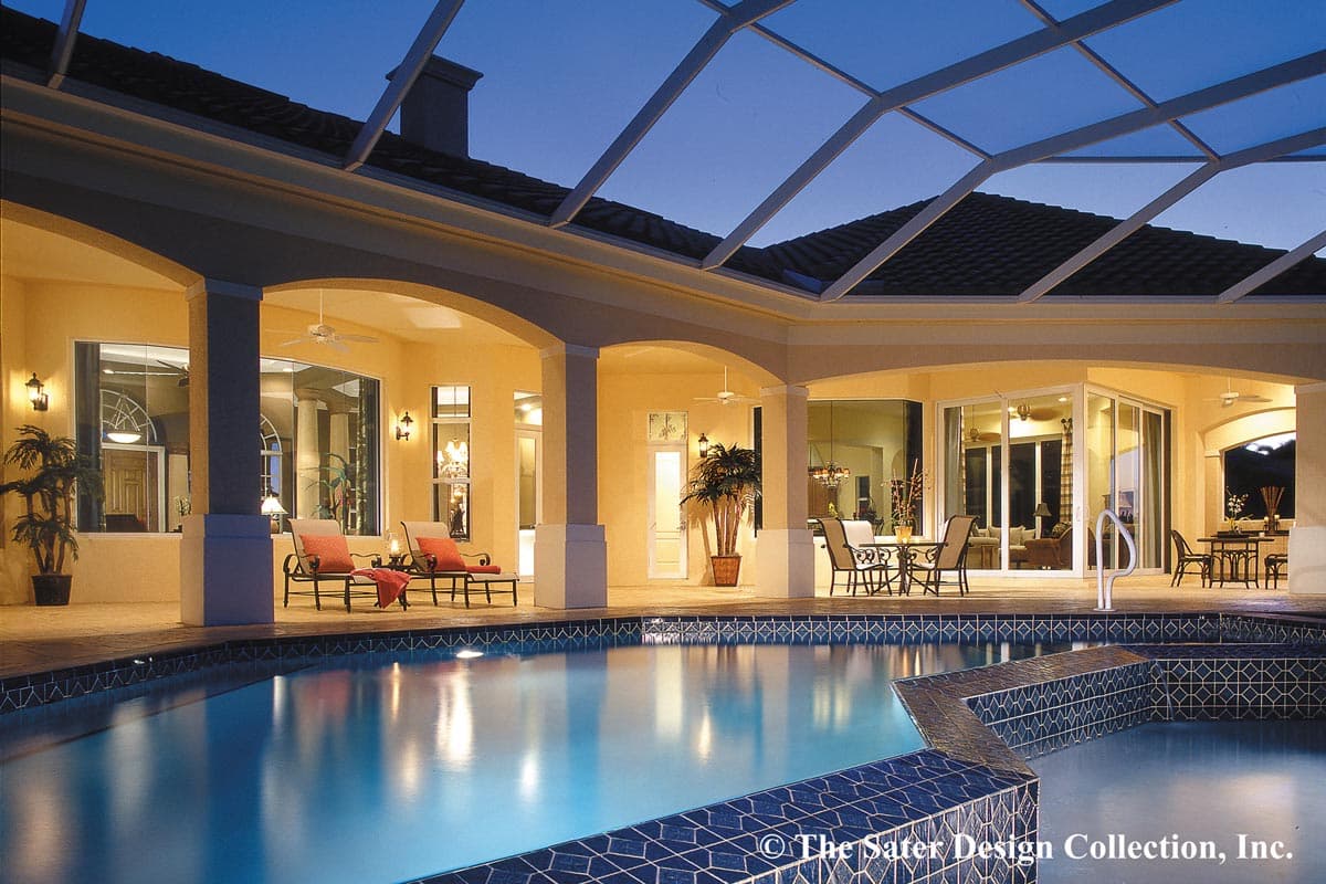 Covered patio with arched openings, columns, and ceiling fans overlooks a pool and open-concept interior.