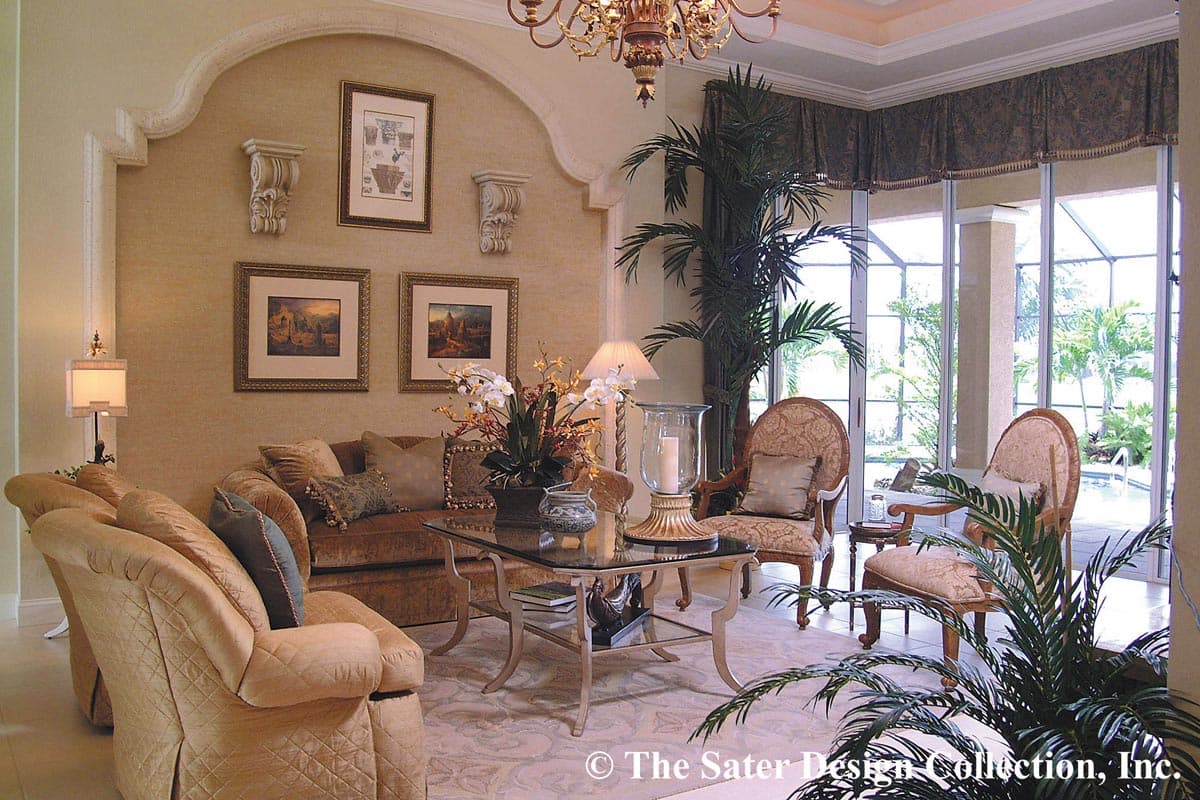 Living room interior with curved archway, upholstered sofas and chairs, glass coffee table, and large windows overlooking a pool.