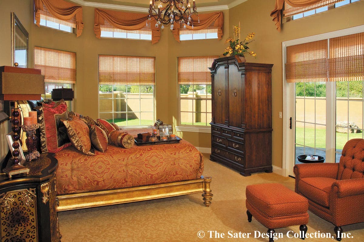 Bedroom with ornate bed, large armoire, multiple windows, and French doors leading to an exterior patio.