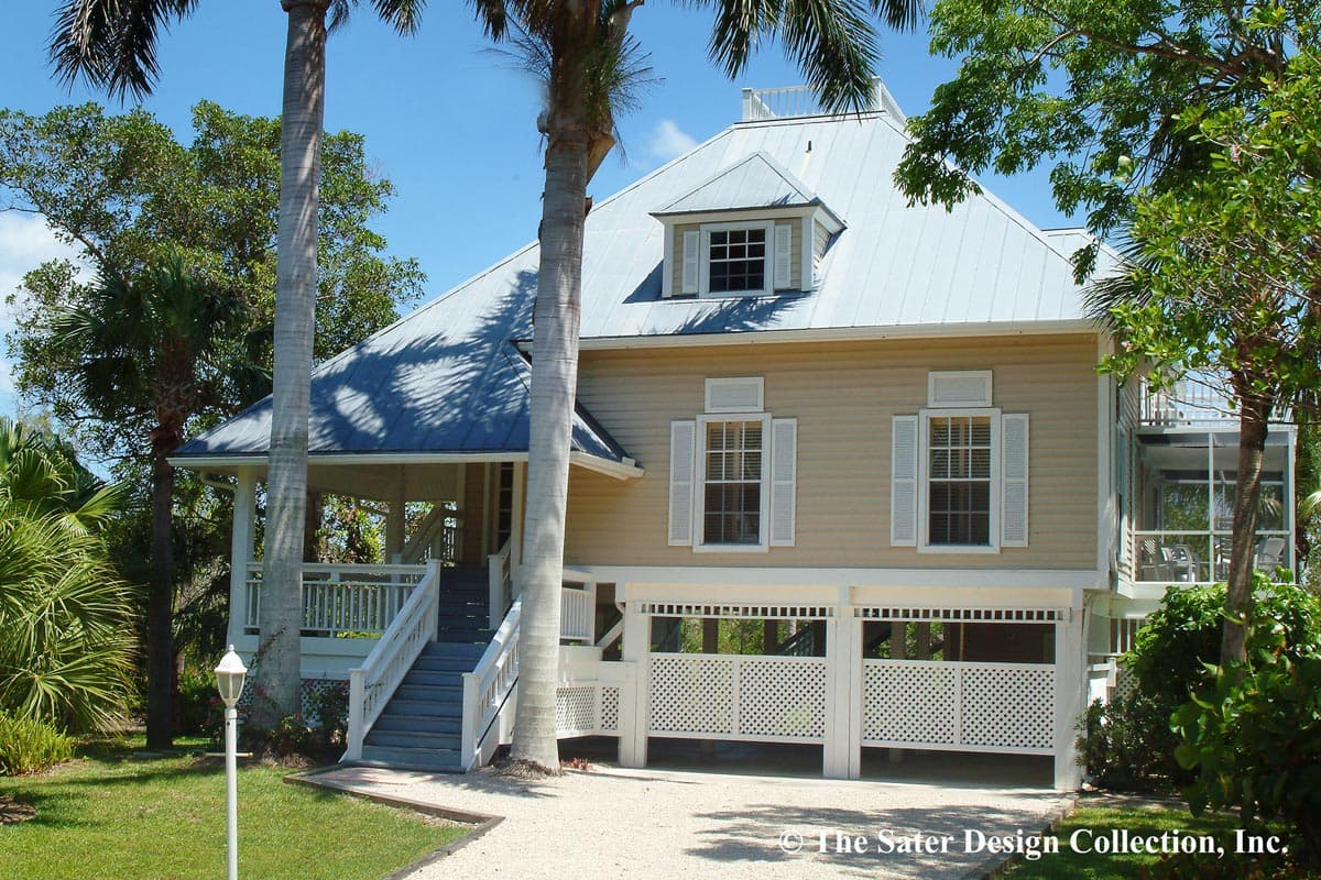 House plan exterior: Two-story coastal home with metal roof, prominent gables, wraparound porch, and elevated living space.