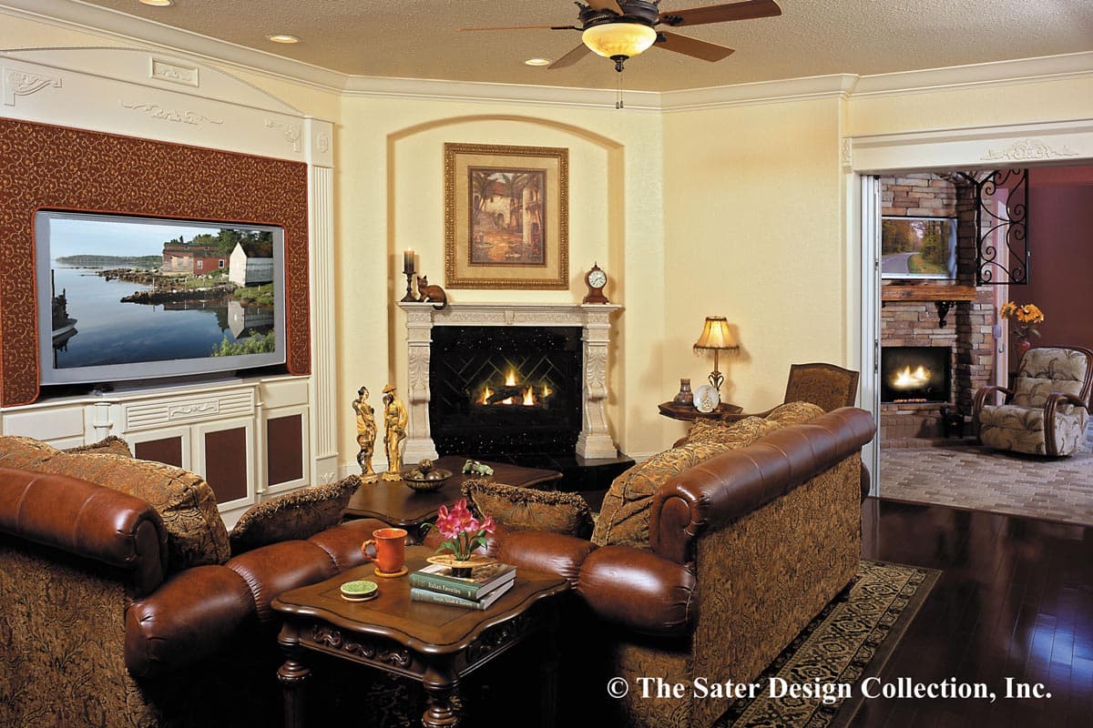 Living room interior with fireplace, entertainment center, and seating area, opening to another room with fireplace.