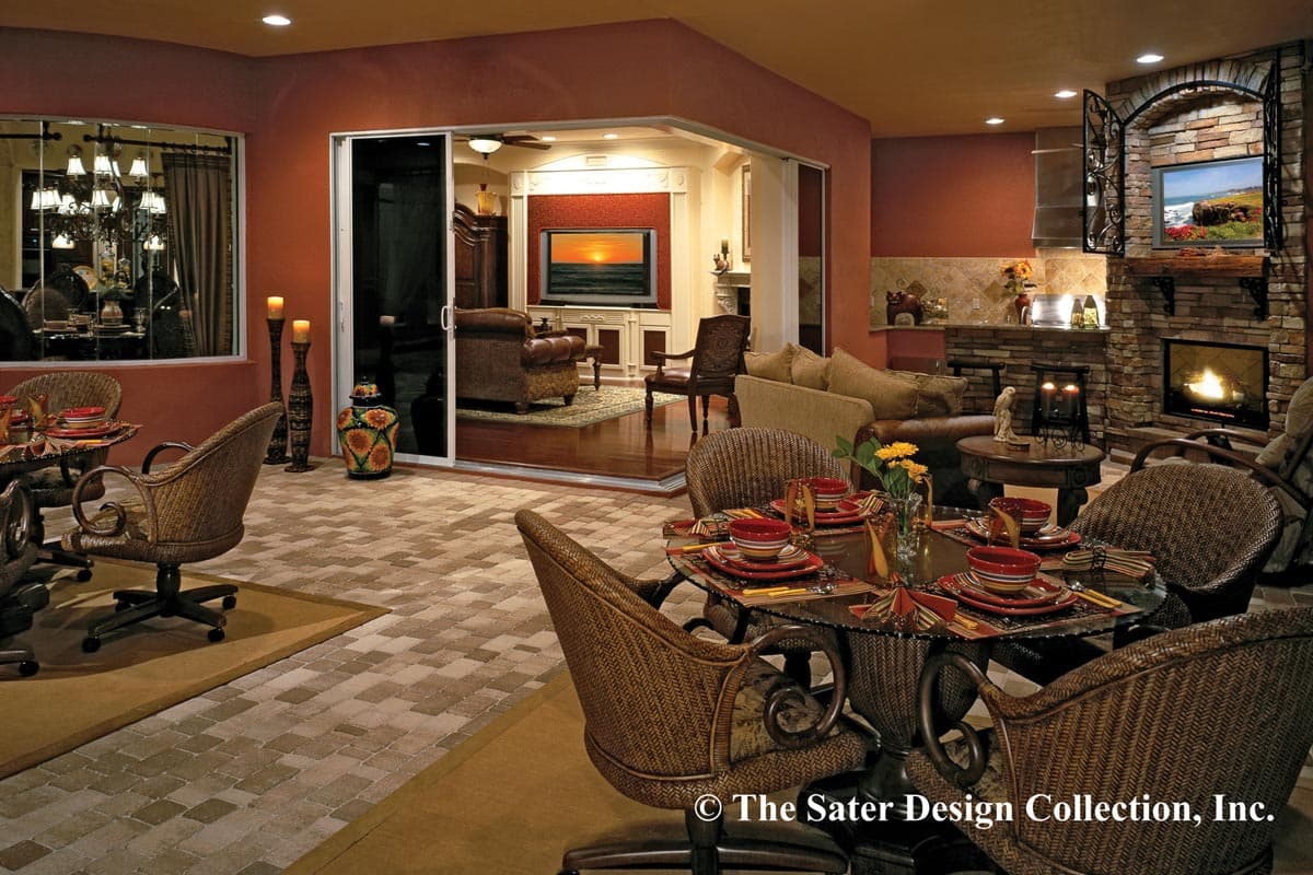 Interior view of a living area with fireplace, television, and dining table with wicker chairs.