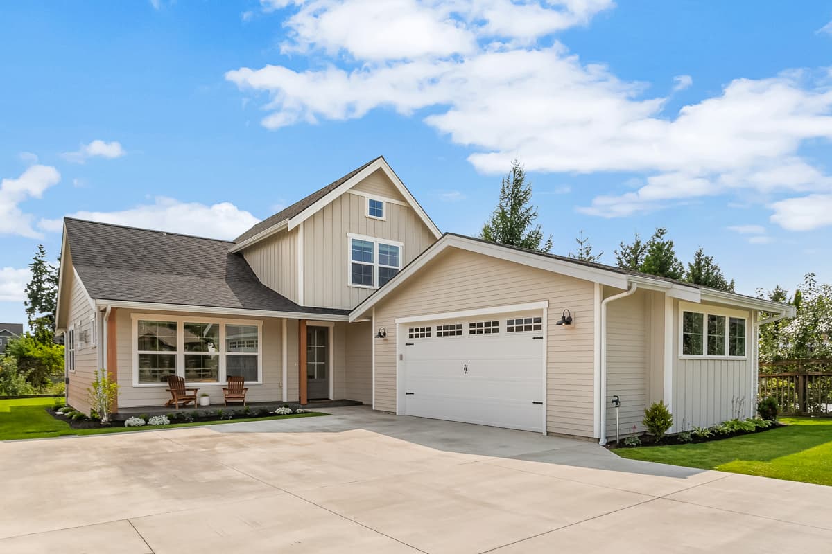 House plan exterior. Two-story Modern Farmhouse with gabled roof, attached garage, and covered porch with exposed support posts.