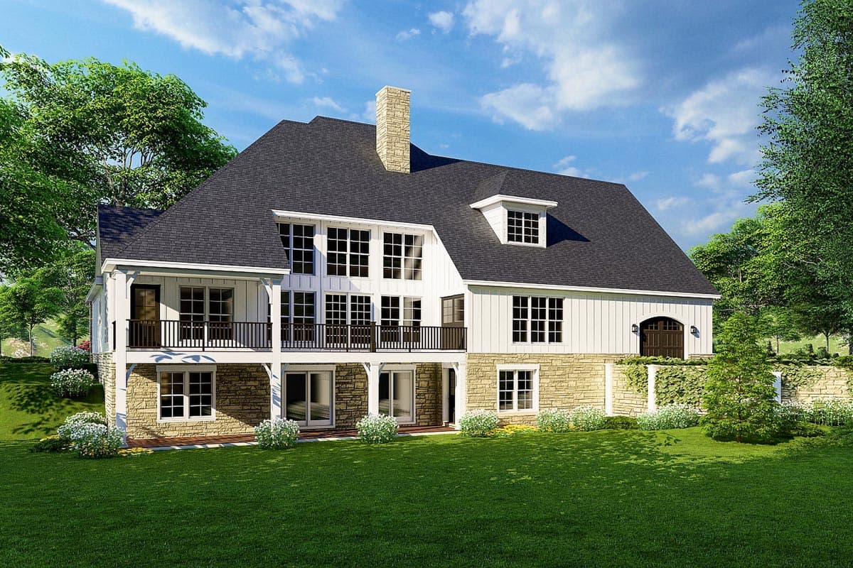 House plan exterior: two-story Modern Farmhouse with stone base, dormer, upper balcony, and arched double garage door.
