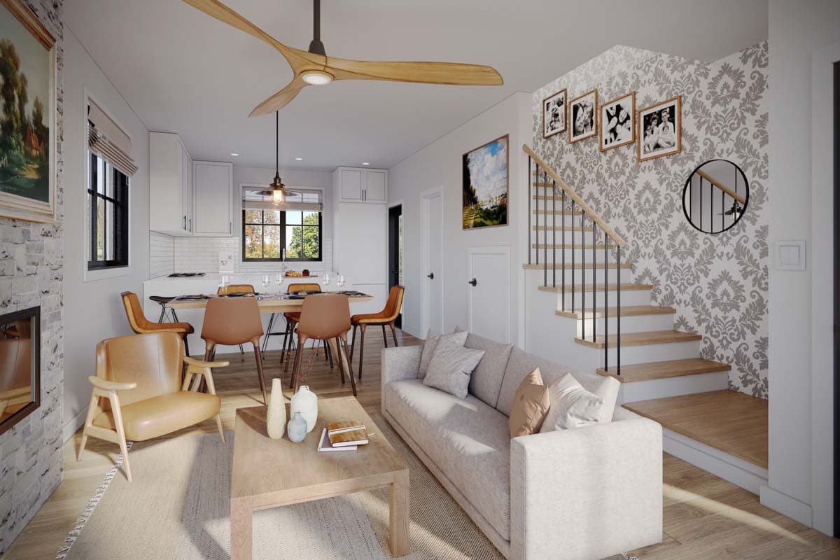 Open concept living area with kitchen, dining, fireplace, stairs, and seating.