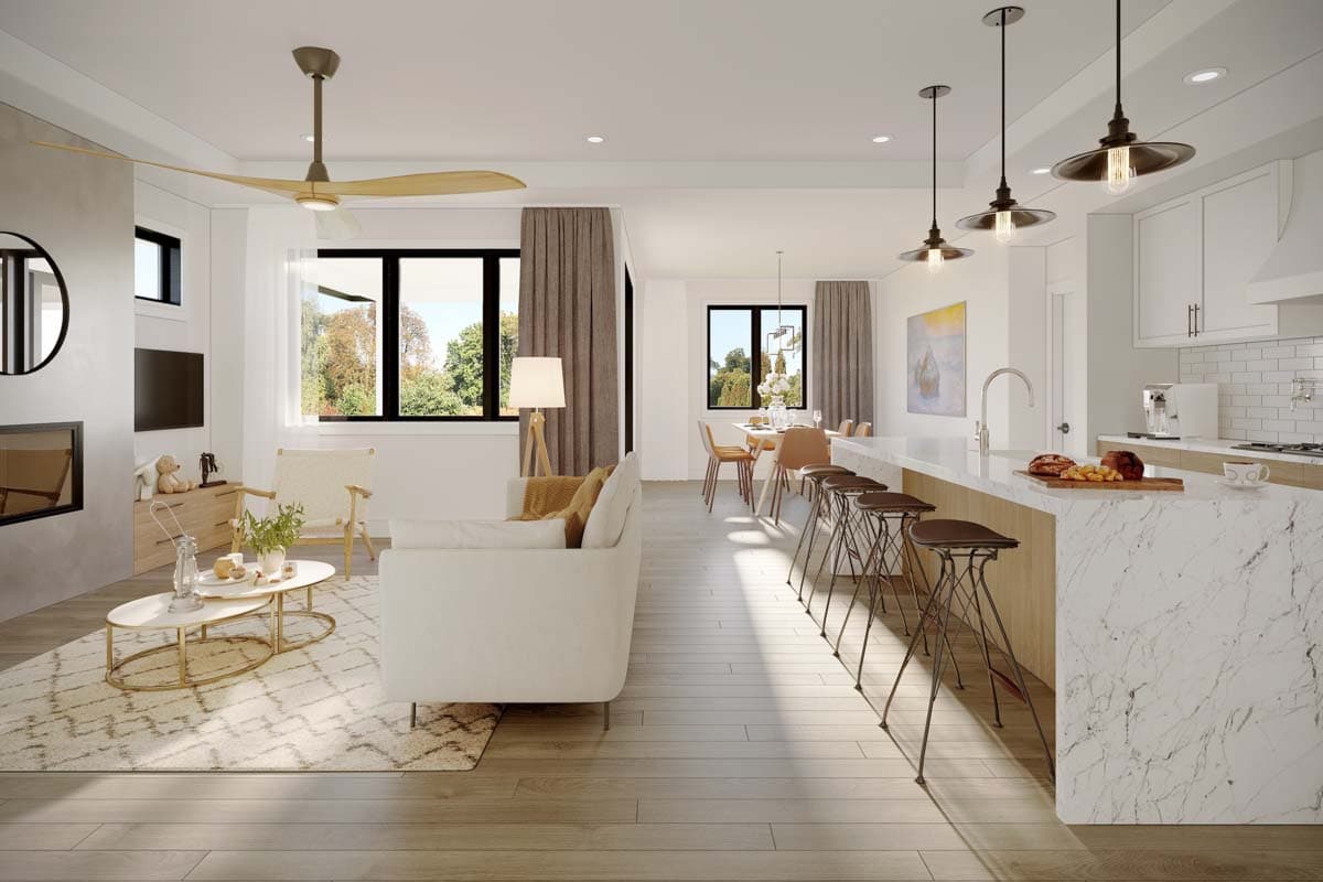Open concept living area and kitchen featuring a fireplace, large windows, island with bar stools, and dining area.