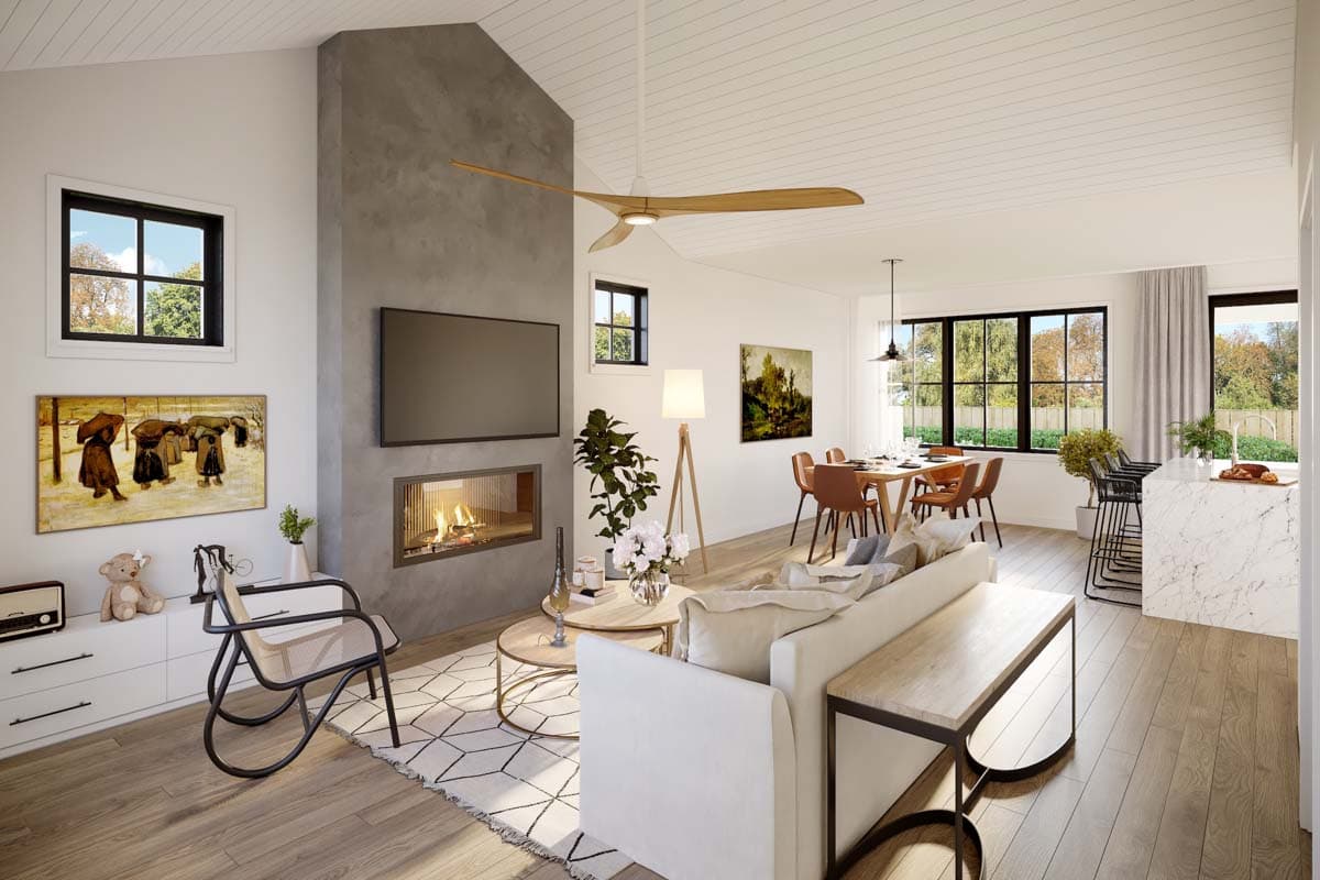 Modern open-plan living area with vaulted ceiling, fireplace, dining area, and kitchen island.