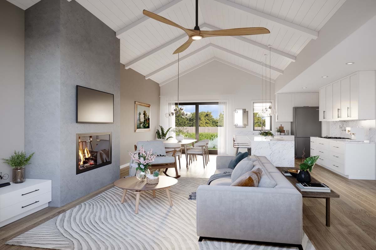 Open-concept living space with vaulted ceiling, fireplace, modern kitchen with island, and dining area.