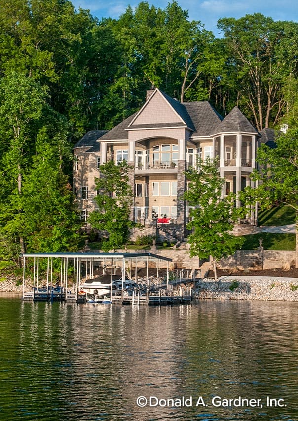 House plan exterior of a multi-story home with multiple balconies, gables, and a boat dock.