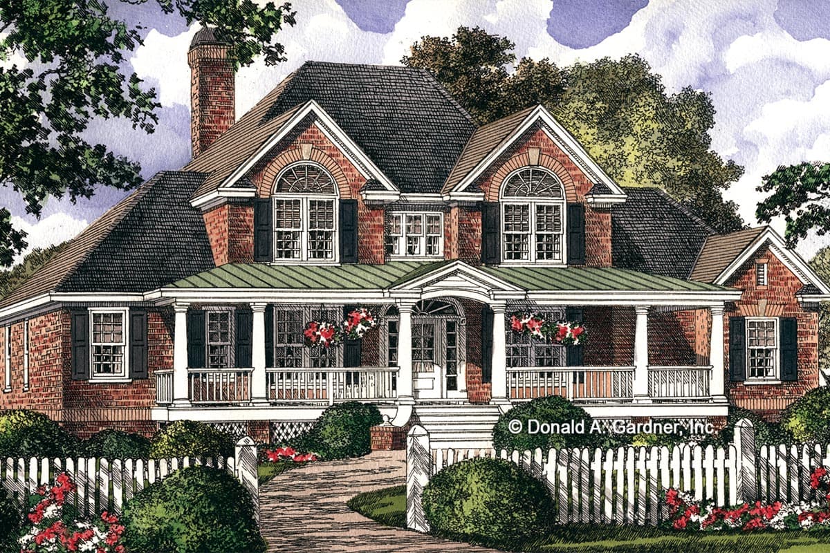 House plan exterior: Brick two-story home with wraparound porch, gables, arched windows, and white picket fence.