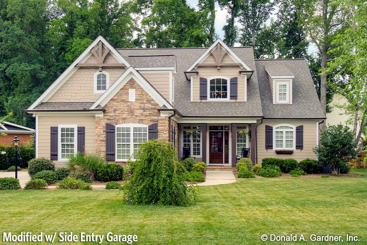 House plan exterior: Two-story home with stone accents, gables, dormers, and a covered front porch with a side-entry garage.