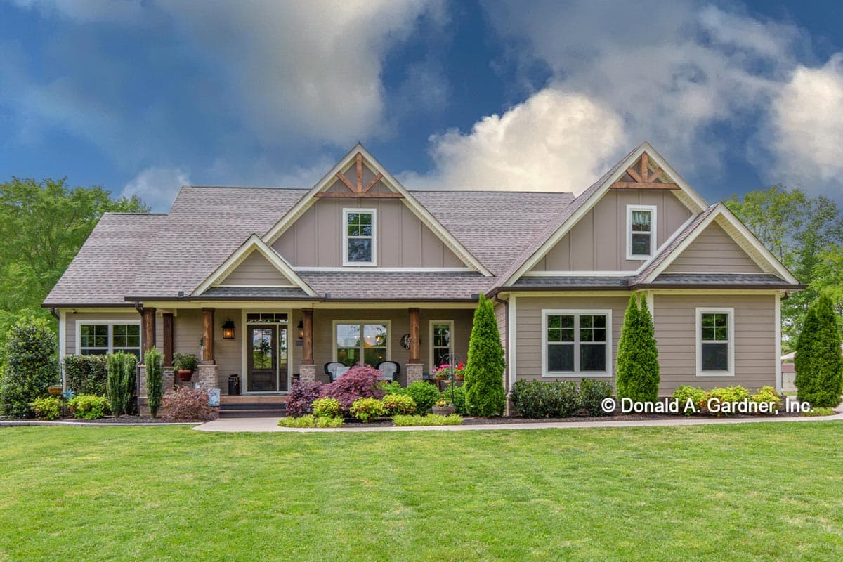 House plan exterior. Craftsman style, single-story home with front porch supported by columns. Features include gabled roof and dormers.