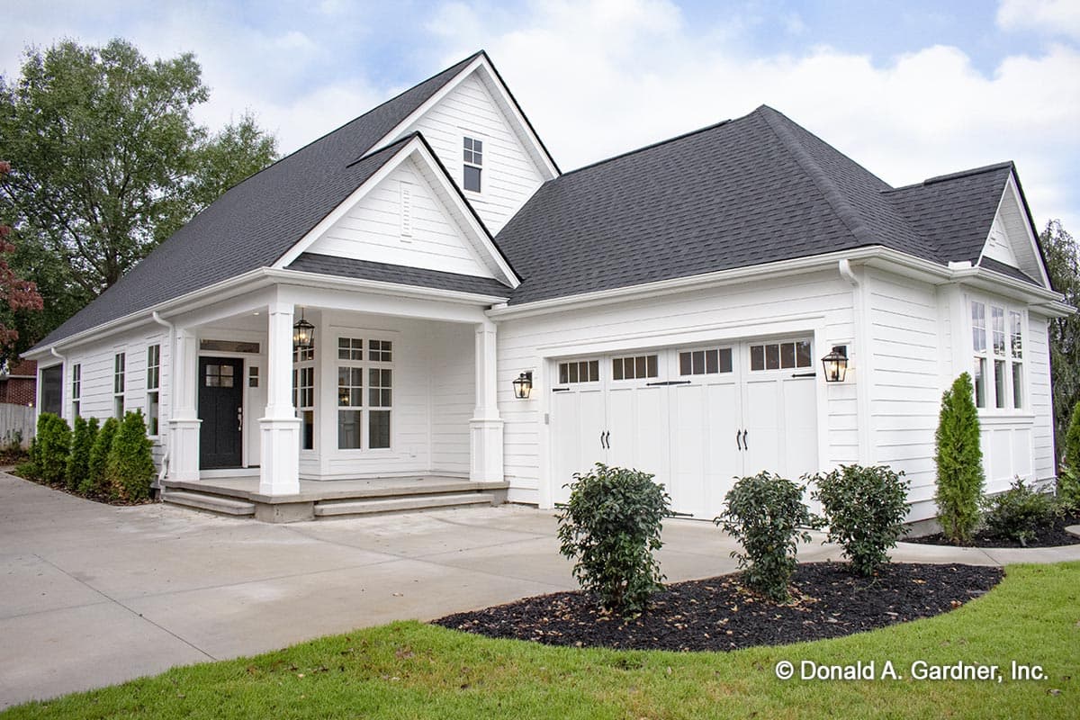 House plan exterior. Two-story Modern Farmhouse with gables, porch with columns, and attached garage. Black asphalt shingle roof.