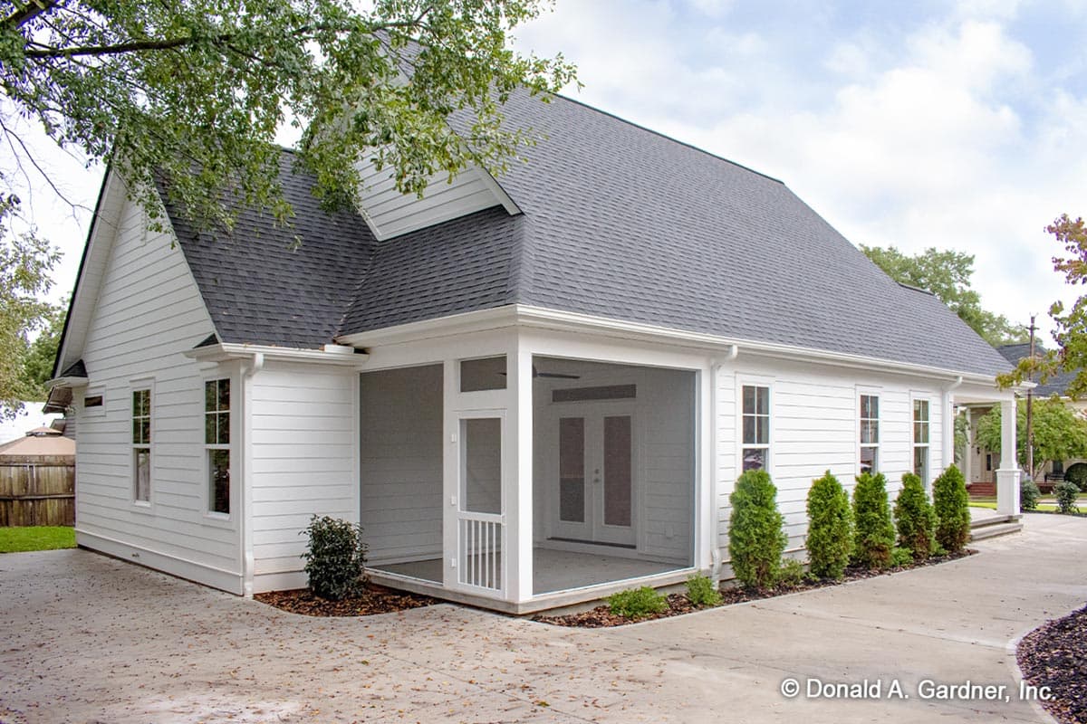 House plan exterior with white siding, gable roof, screened porch, and attached garage. One story.