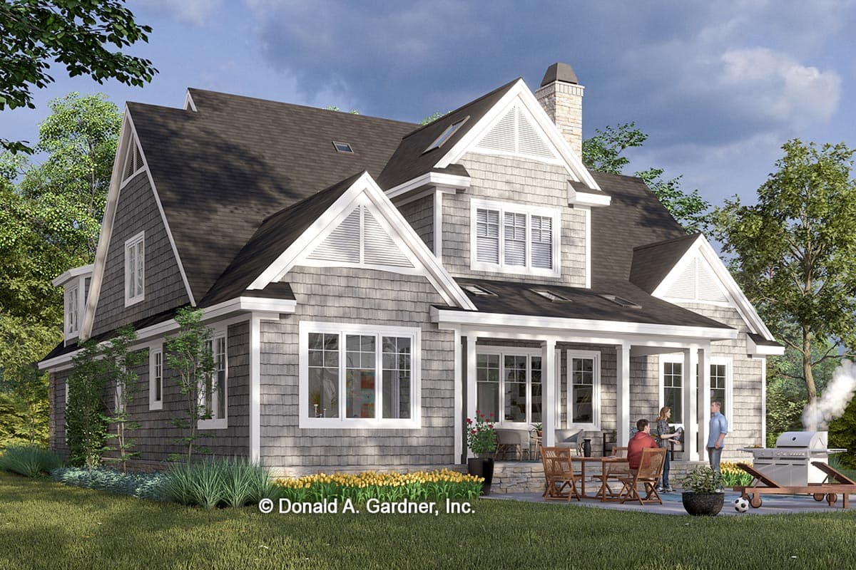House plan exterior with gabled dormers, stone chimney, and covered porch. Shingle siding and multiple gables.