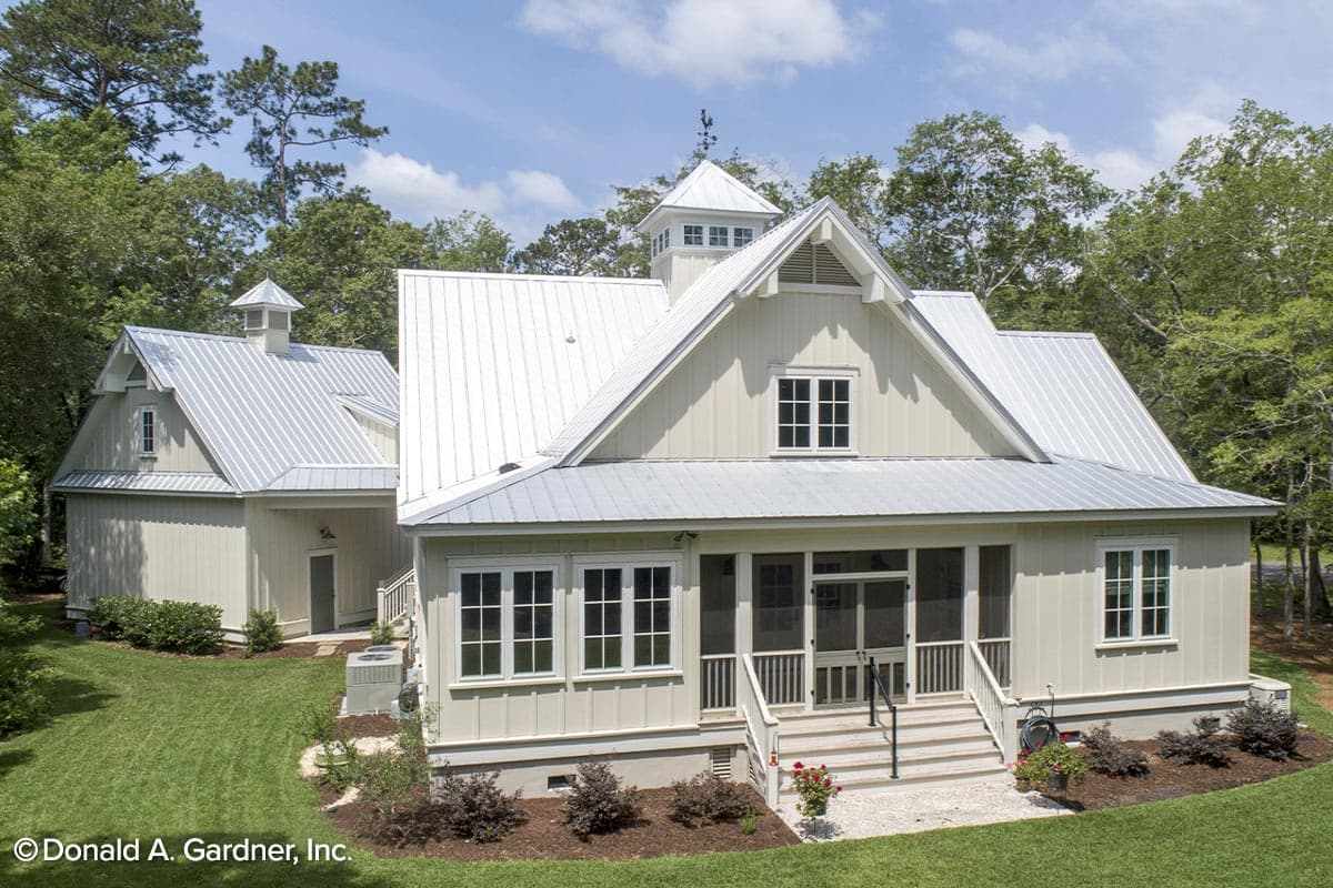 House plan exterior with a metal roof, cupola, screened porch, and attached garage with a cupola.