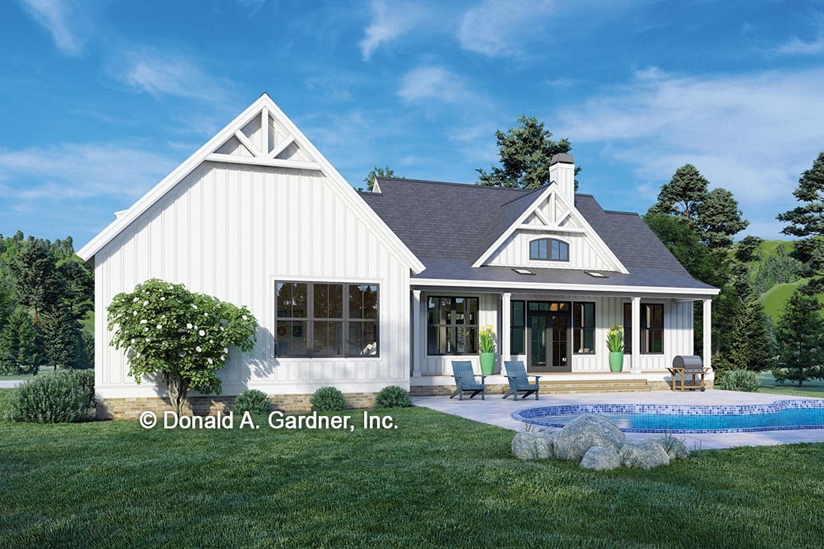 Rear exterior rendering of a white farmhouse.  Features a gable roof and board and batten siding.  Greenery surrounds.