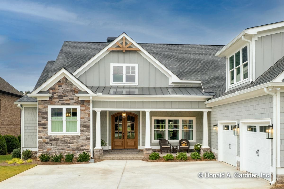 House plan exterior: Modern Farmhouse style with stone accents, covered porch, double garage doors, and prominent gables.