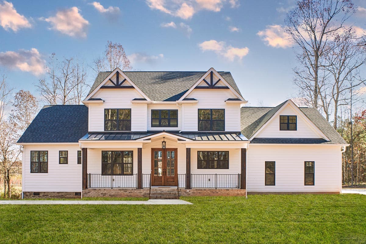 House plan exterior. Two-story Modern Farmhouse with gabled roof, front porch, and black-framed windows.