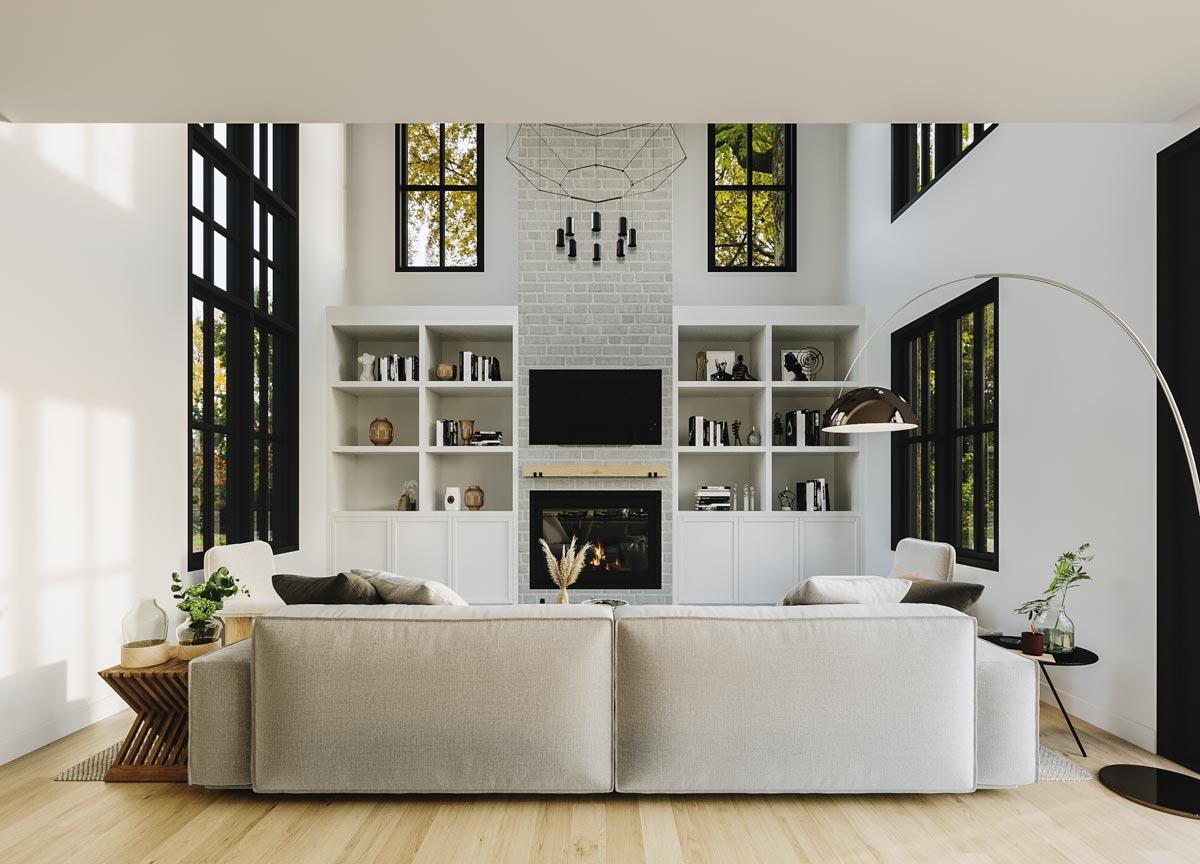 Interior rendering of a great room with a vaulted ceiling, floor-to-ceiling built-in shelving, a brick fireplace, and large windows.