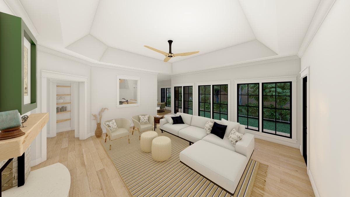 Interior rendering of a living room with a tray ceiling, large sectional sofa, fireplace, and numerous windows.