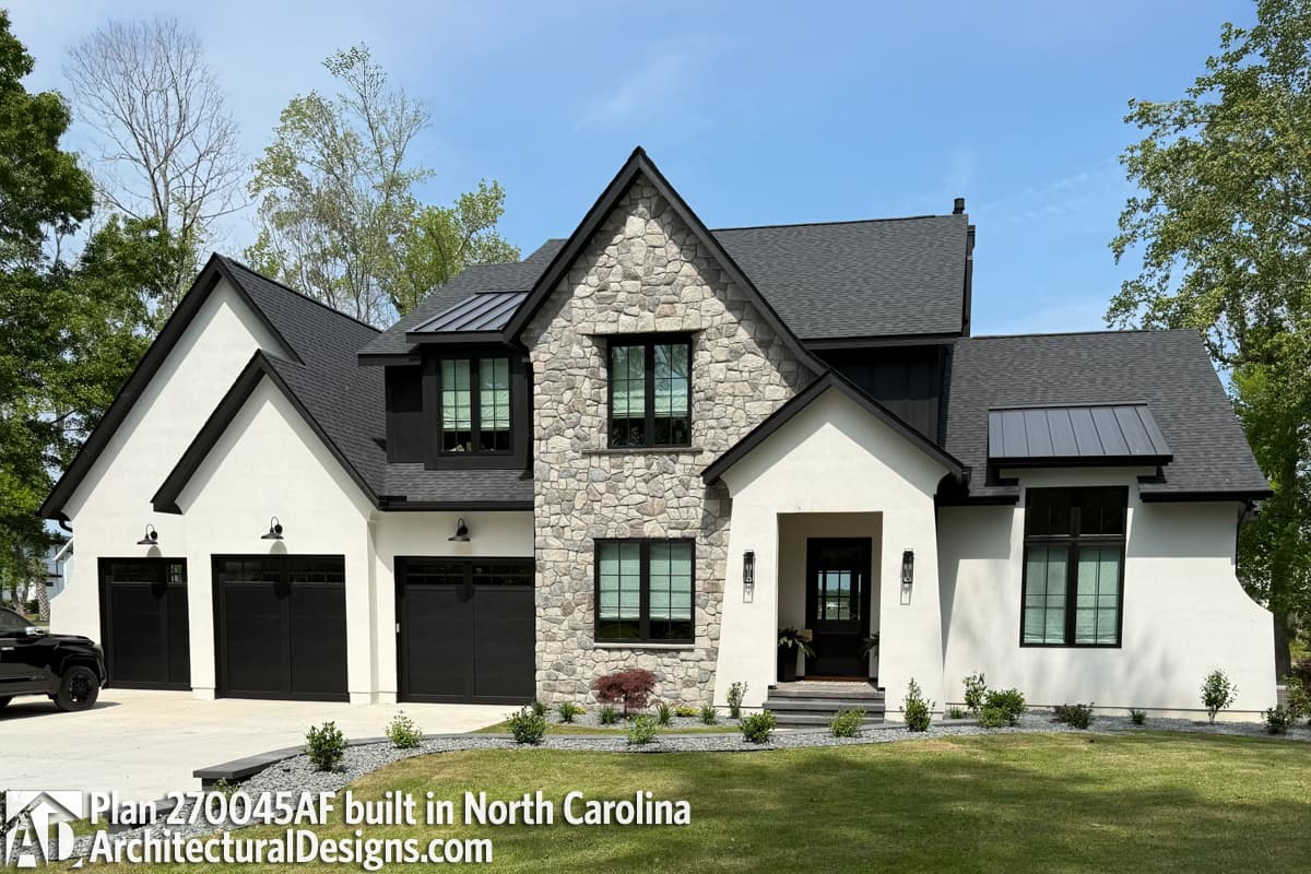 House plan exterior: Two-story Modern Farmhouse with stucco and stone facade, three-car garage, and metal roof accents.