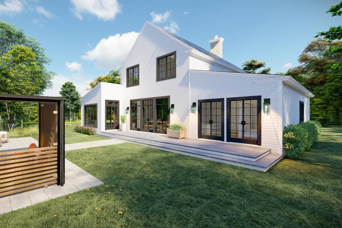Modern house plan exterior with a prominent gable, white siding, large black-framed windows, and a raised patio.