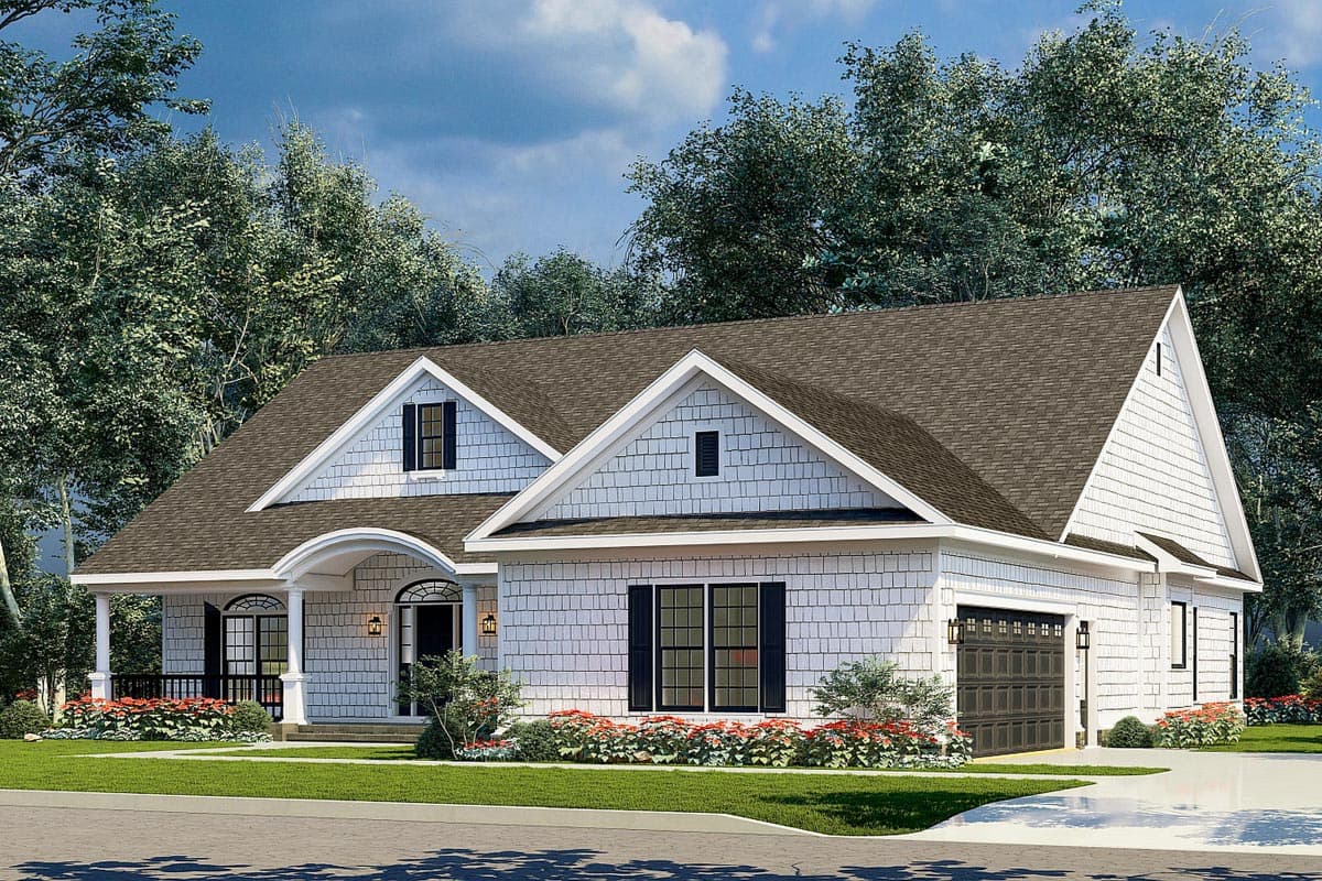 House plan exterior: One-and-a-half story, white shingle siding, arched entry porch, prominent gables with dormers, and attached garage.