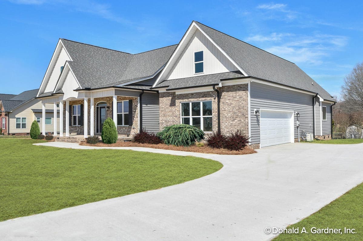 One-story house plan exterior with covered front porch, dual gables, and attached two-car garage.
