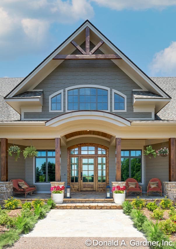 House plan exterior: Craftsman style, two stories, with a covered porch, arched entry, and prominent gable with exposed beams.