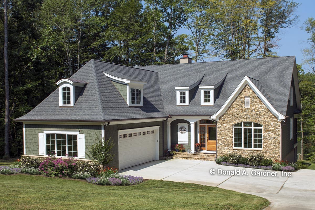 House plan exterior with stone accents, dormers, and a gabled roof. Features include an attached garage and front porch with columns.