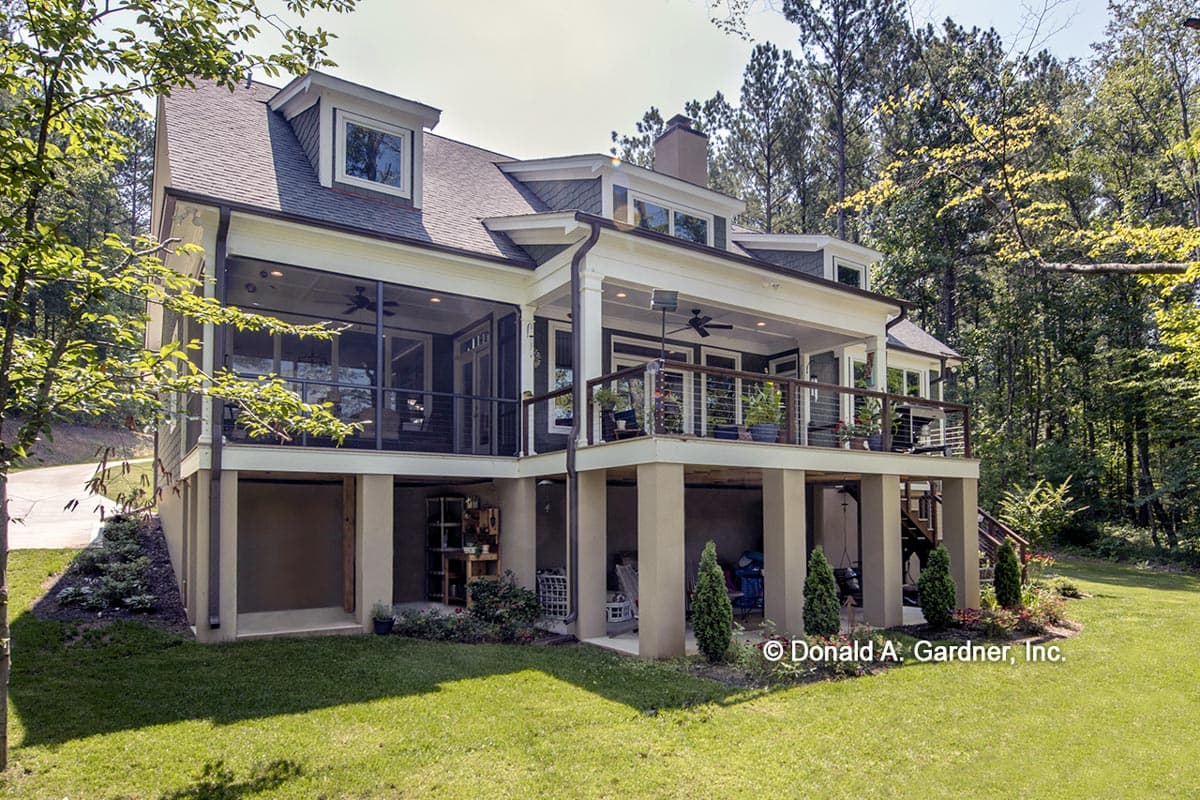 House plan exterior of a two-story home featuring dormers, a screened porch, and an elevated deck.