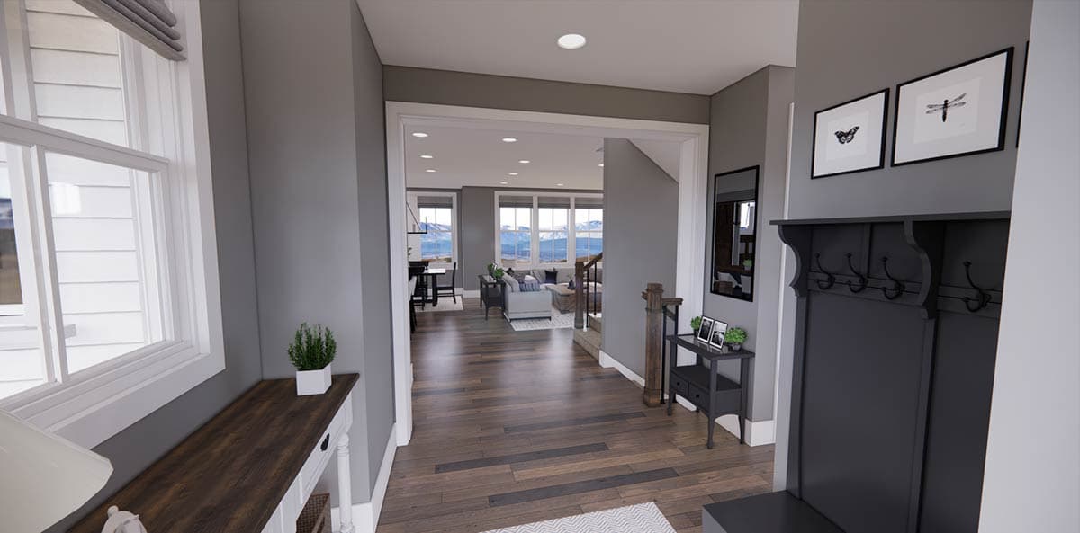 A modern entryway with dark wood flooring leads to a living area and staircase. A coat rack and small table with decor are to the right.