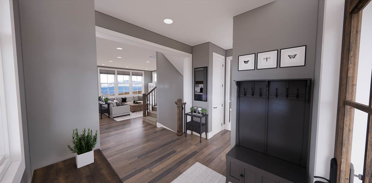 A modern home interior showcasing a foyer with a coat rack, framed art, and a glimpse into a living room with a mountain view.
