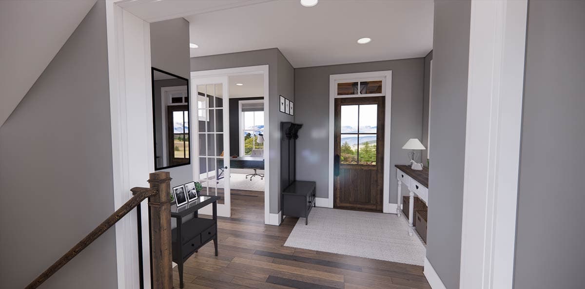 Interior view of a house hallway with wooden floors and dark gray walls. A front door, a mirror, and an office can be seen.