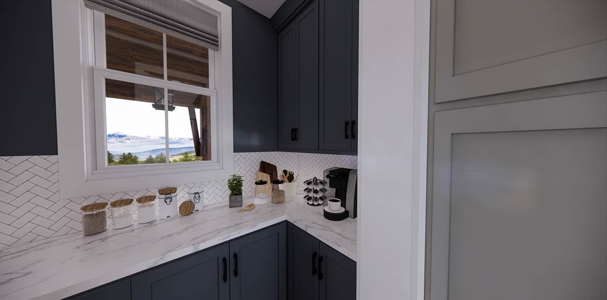 A modern kitchen pantry with navy blue cabinets, a marble countertop, and a window with a mountain view outside.