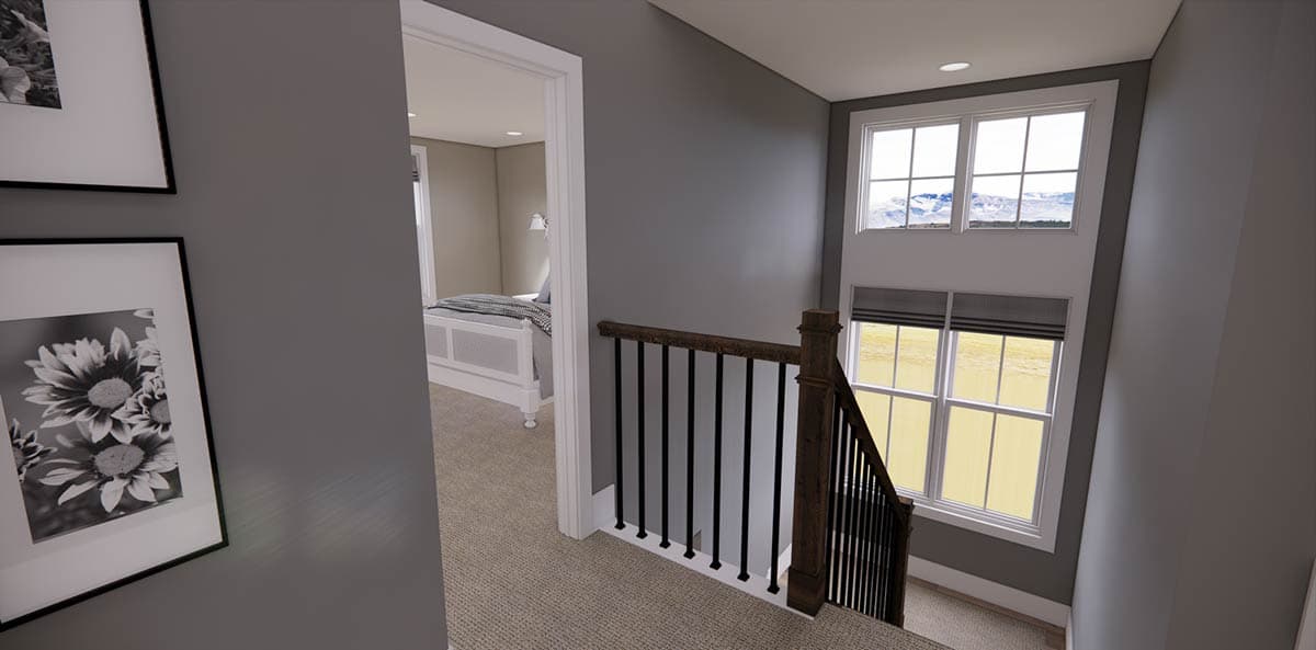 Interior view of a stairway landing with a large window and a doorway leading to a bedroom. Black and white floral art hangs on the wall.