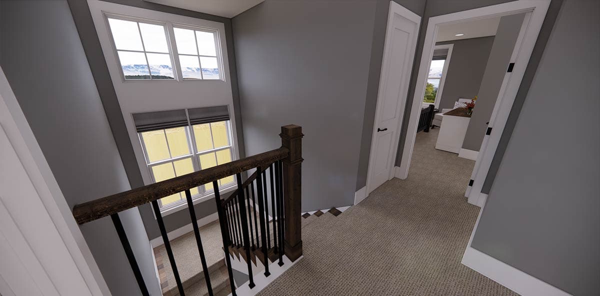 A hallway landing with a staircase leading down, featuring a dark wood banister and a window with a mountain view outside.