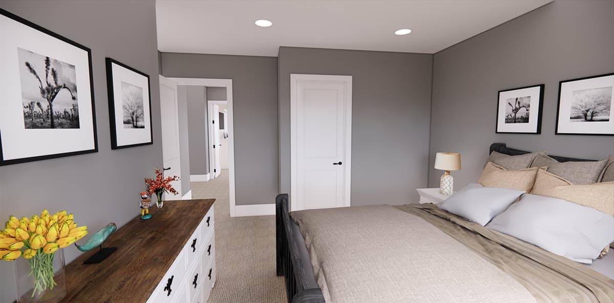 Bedroom interior with gray walls, black and white framed art, a bed with neutral bedding, and a decorative dresser. A door leads to the hallway.