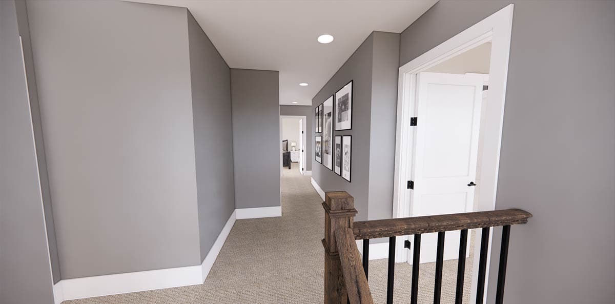 A hallway with gray walls, white trim, and a patterned carpet. White doors are open, and a staircase railing is in the foreground.