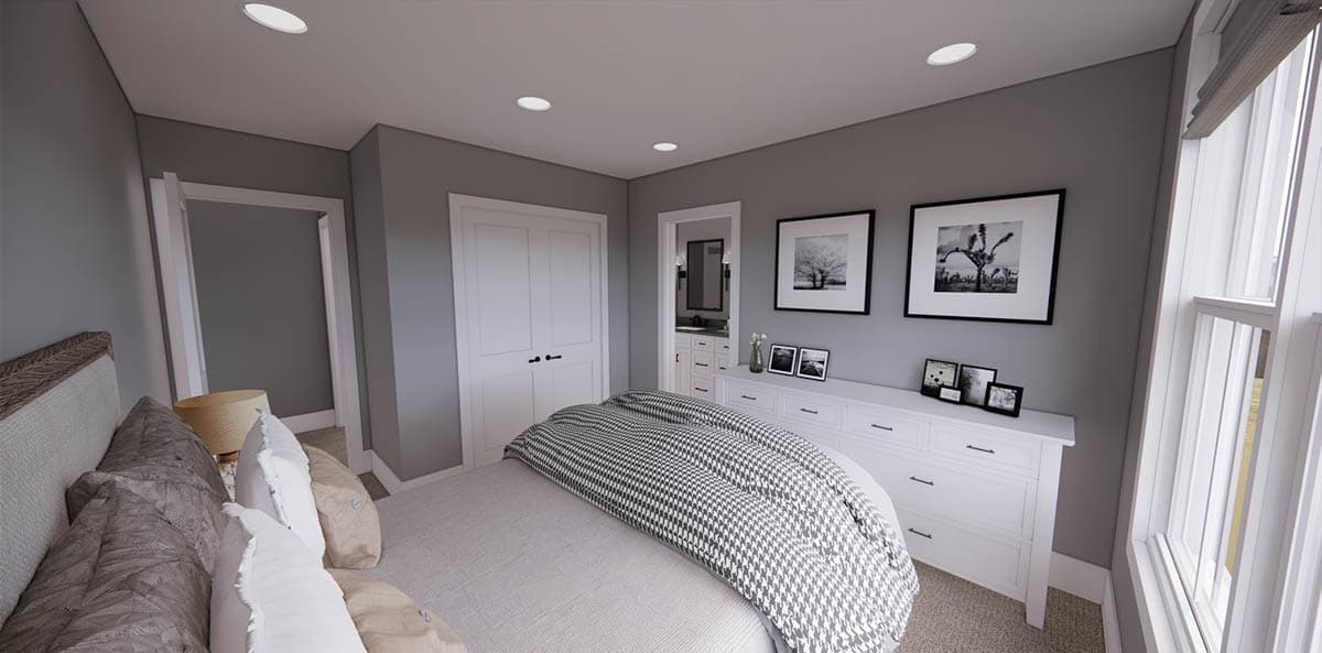 A modern bedroom interior features a bed with patterned bedding, a white dresser with framed art, and a partially visible en-suite bathroom.