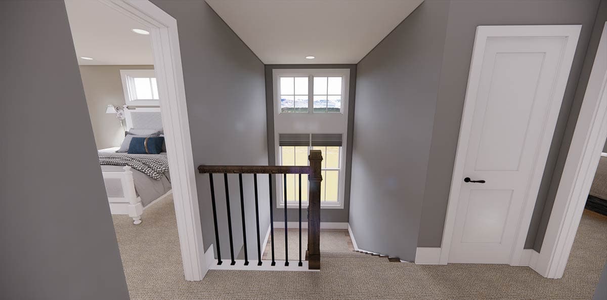 A hallway with a stairwell leading to a small landing with a window, and doors leading to bedrooms.