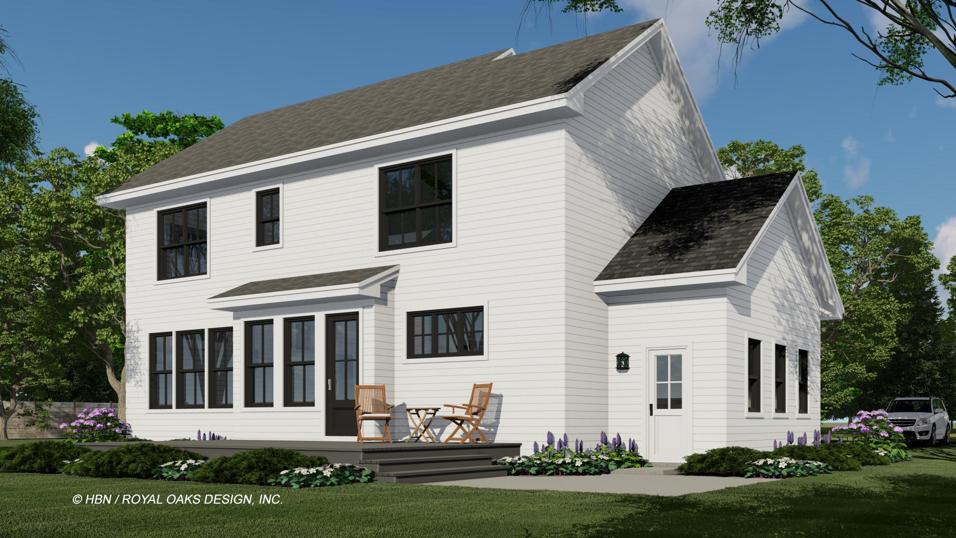 A modern two-story white house with black window frames, a gray roof, and a small porch with two chairs and a table. Landscaping surrounds the house.