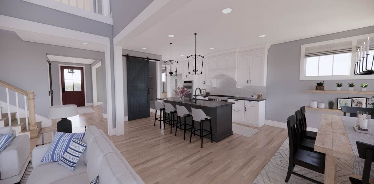 Spacious, modern kitchen and dining area. Features a large island with bar stools, white cabinetry, and a dining table set near a window.