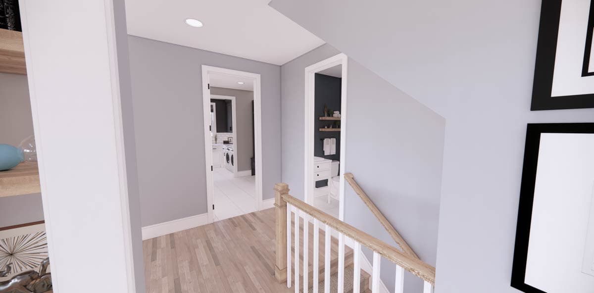 Interior hallway with light grey walls, wooden floor, and an adjacent staircase. Doors lead to other rooms including a laundry area.